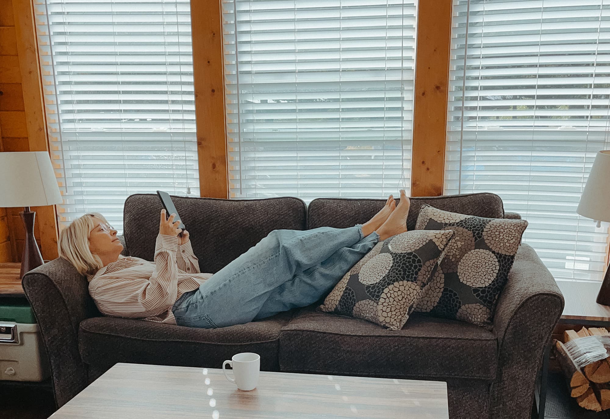 woman reading a book on sofa