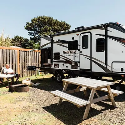A man sitting in a chair outside his RV at Hart's Camp